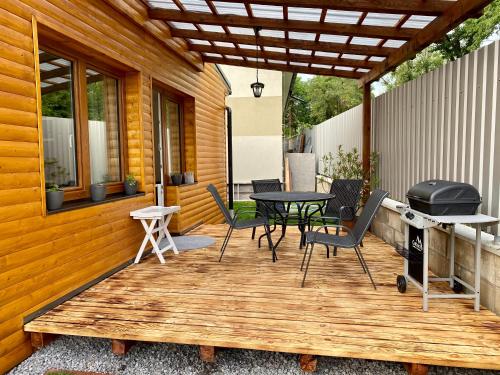 a patio with a table and chairs and a grill at P&P APARTMÁNY Bojnice in Bojnice