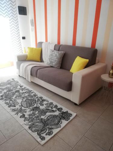 a couch sitting in a living room with a rug at Apartments Tellaro in Tellaro