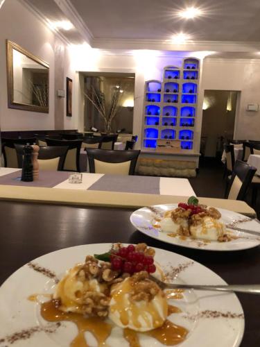 two plates of food on a table in a restaurant at Hotel Friedrich in Hachenburg