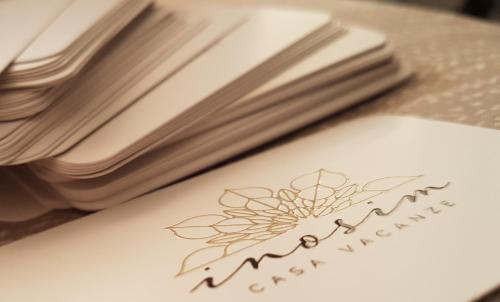 a book with a flower on it next to some books at Inosim - Casa vacanze in Selargius