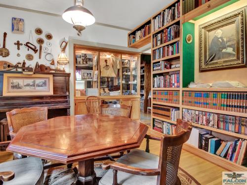 a dining room with a table and chairs and bookshelves at Robins Nest Bed & Breakfast in Cody