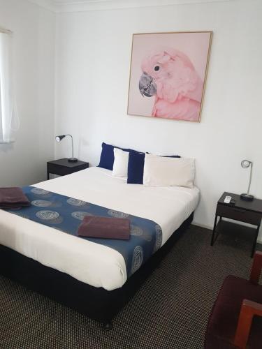 a bedroom with a bed with a picture of a dog on it at Canberra Ave Villas in Queanbeyan