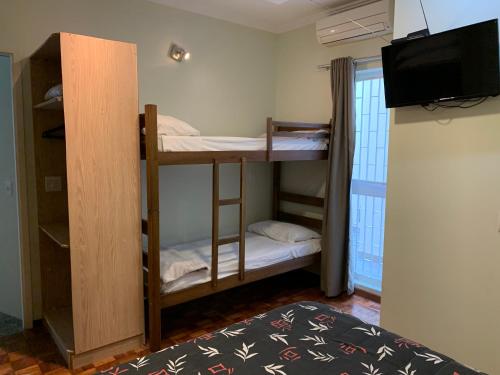 Cama ou camas em um quarto em Vila Stellino Suítes