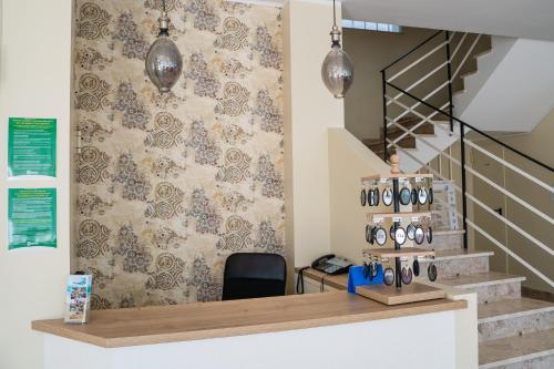 a room with a counter with a wall with a staircase at Hotel Happy in Milano Marittima
