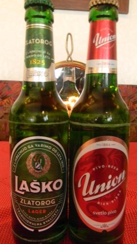 two bottles of beer sitting on top of a table at Hotel Krona Domžale in Domžale