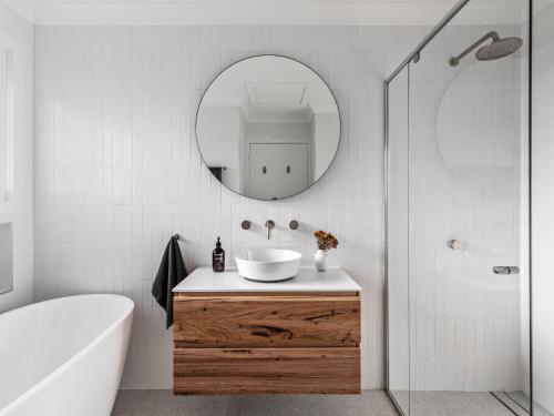 a bathroom with a sink and a mirror at Ohana in Gerroa