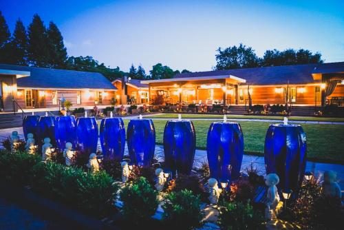 a row of blue vases in a garden at night at Bann at Oak Knoll Napa in Napa