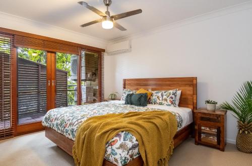 a bedroom with a bed and a ceiling fan at Oceanic Blue - East Ballina in East Ballina
