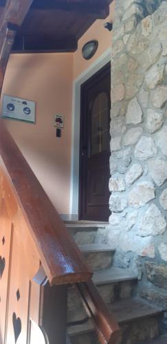 a stairway with a door and a stone wall at Apartment Tarman in Jesenice