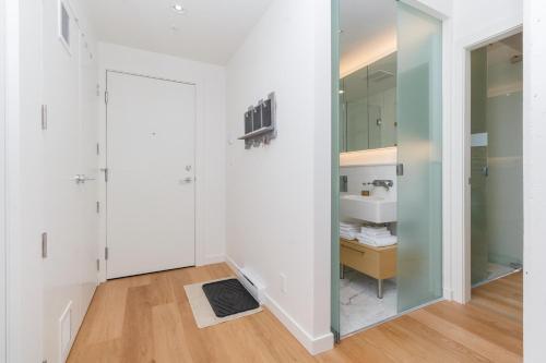 a bathroom with a sink and a mirror at Historic Waterside With Spectacular Johnson Bridge Views in Victoria