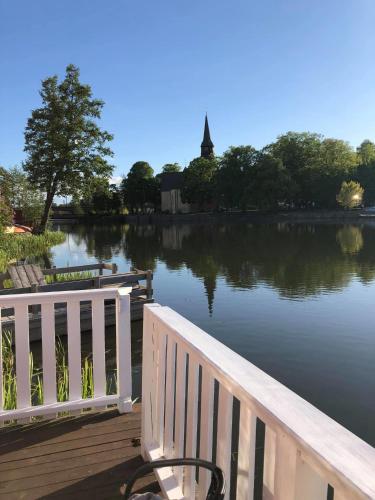 a wooden dock with a bench and a lake at Stugan med Bryggan i Gamla Staden in Eskilstuna