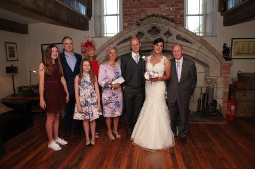 a group of people posing for a picture at a wedding at The Old Flax Mill Yoga Retreat in Coleraine