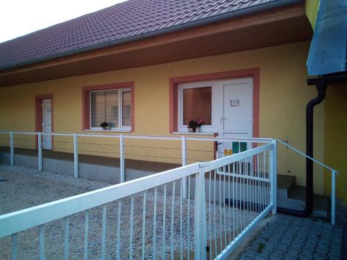 a house with two windows and a white railing at Ubytovanie na dedine in Veľká Chocholná