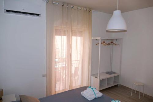 a room with a window and a table with towels at Pepi B&B in Santa Maria di Castellabate