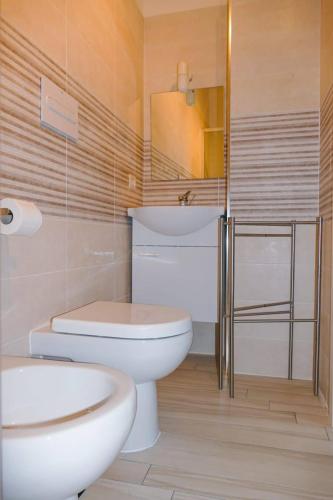 a bathroom with a toilet and a sink at Pepi B&B in Santa Maria di Castellabate