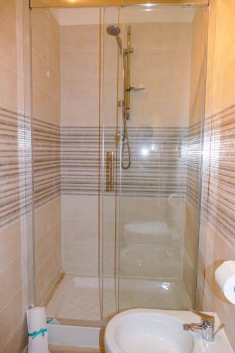 a bathroom with a shower and a toilet and a sink at Pepi B&B in Santa Maria di Castellabate