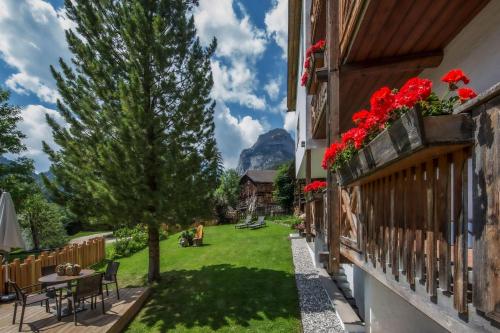 a view from the balcony of a house with red flowers at Residence Sas Vanna in La Villa