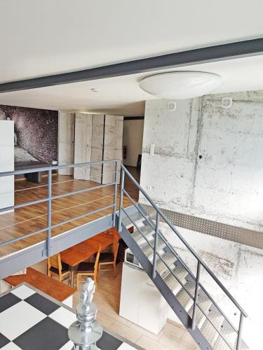 a room with stairs and a checkered floor at Loft-Unterkunft in Sinsheim