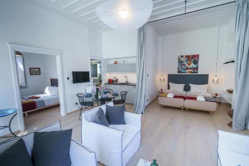 a living room with a couch and a room with a bed at Livin Hydra Private Collection Suite 3 in Hydra