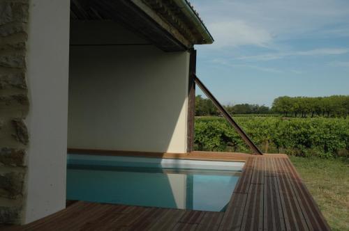 a house with a swimming pool and a window at Domaine de Sévanes in Saint-Paul-les-Fonts