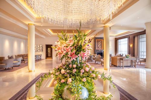 a lobby with a large centerpiece of flowers and a chandelier at Mullingar Park Hotel in Mullingar