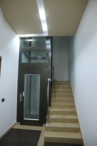 a stairway with a black door and a stair case at La Luna e il Sole in Barletta