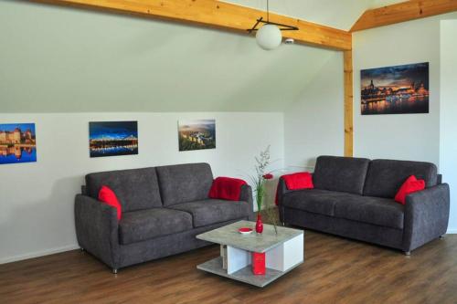 a living room with two couches and a coffee table at Ferienwohnung „Zum Leuchtturm“ in Großdubrau