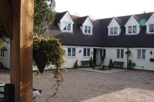 a row of white houses with windows and plants at Park Farm in Windsor