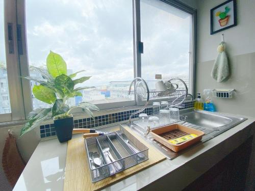 a kitchen counter with a sink and a window at Cozy family room At 103 condominium 2 on nimman 12 in Chiang Mai