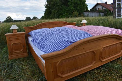 
a bed that is made out of wood at Open air, Bett im Kornfeld in Finning

