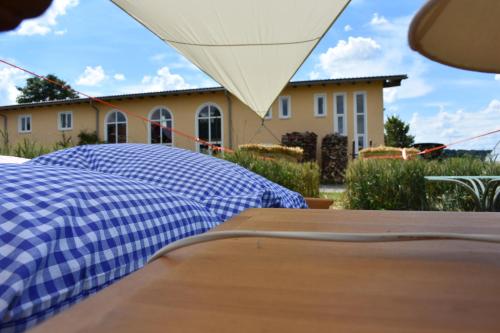 
a bed sitting in front of a house at Open air, Bett im Kornfeld in Finning
