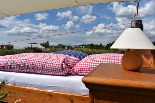 
a bed with pillows and a lamp on top of it at Open air, Bett im Kornfeld in Finning
