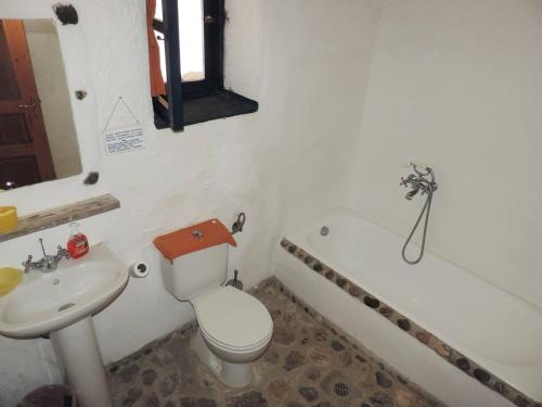 e bagno con servizi igienici, lavandino e vasca. di Exclusive apartment in Ecovilla on the beach ad Apolakkiá