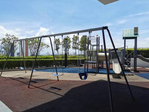 an empty playground with a swing at Entire Condominium @ Woodsburry Butterworth Penang in Butterworth