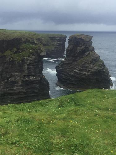 two large rocks in the ocean near the ocean at Gurraun House in Kilkee