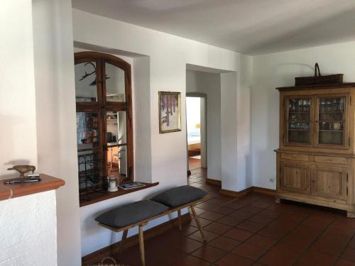 a living room with a bench and a cabinet at Chiemgau, Seeblick, Haus am Weinberg, 83370 Seeon Oberbayern in Seeon-Seebruck