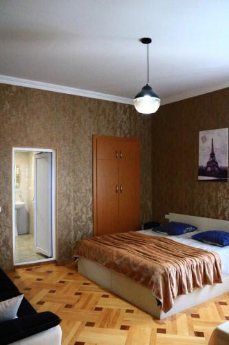 a bedroom with a large bed and a mirror at Sighnaghi Inn in Sighnaghi