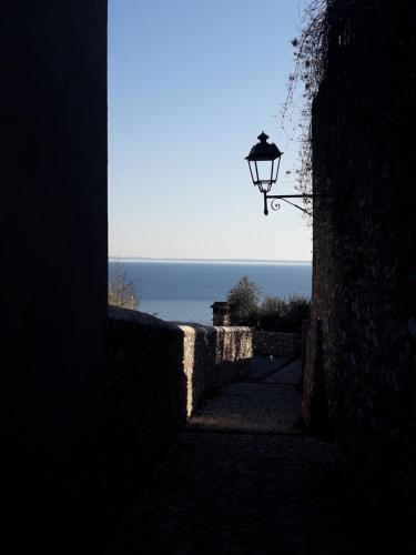an alley with a street light and a view of the ocean at Cà del borgo Historic Village in Toscolano Maderno