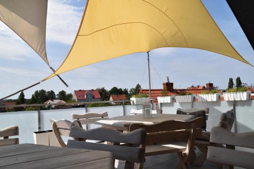 a yellow umbrella on top of a roof at Gdanziger Dom in Gdańsk