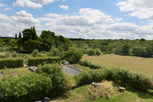 an overhead view of a garden with bushes and trees at Sissinghurst Castle Farmhouse in Sissinghurst