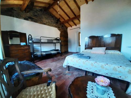 a bedroom with two beds and a table and a chair at Antica Calvasino in Lezzeno