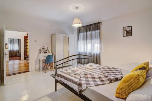 a bedroom with a bed and a desk in a room at Vacation home Korina in Senj