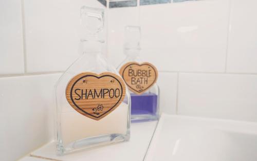 a bottle of shampoo sitting on top of a counter at Hundred House Hotel in Ironbridge