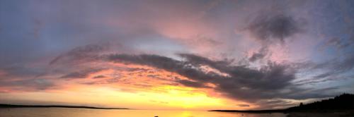 a sunset with a large cloud formation over the water at Sea View Studio Apartments by the Beach in Ihasalu