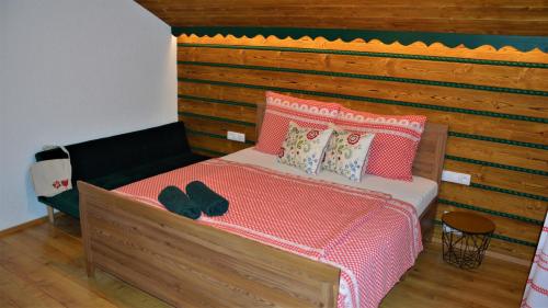 a bedroom with a bed with a wooden headboard at Apartmán Elenka in Zuberec