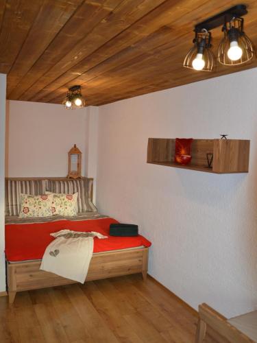 a bedroom with a bed and a wooden ceiling at Apartmán Elenka in Zuberec