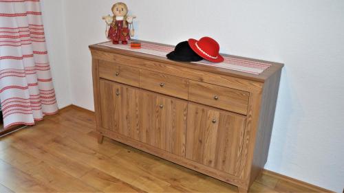a wooden cabinet with a hat on top of it at Apartmán Elenka in Zuberec