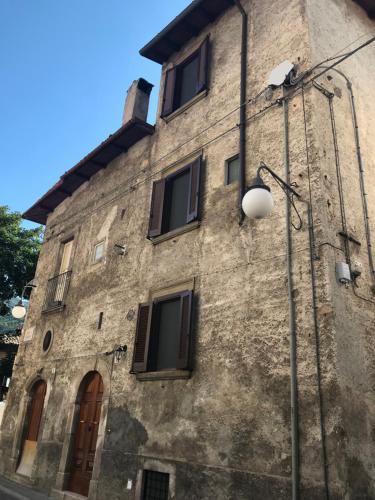 an old stone building with windows and a street light at Alla Piazza Vecchia in Scanno
