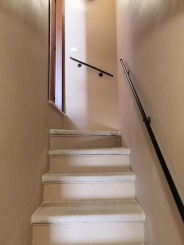 a set of stairs with a window and a clock at Alla Piazza Vecchia in Scanno