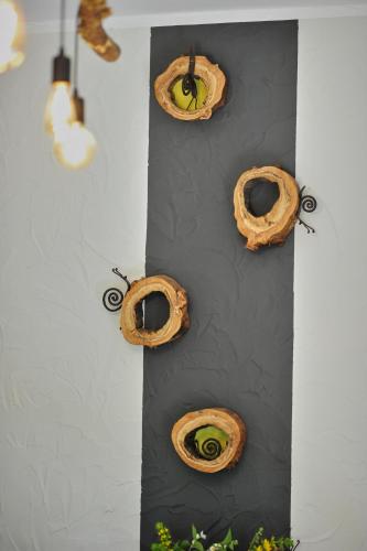 a wall with a bunch of bagels on it at La Babillarde in Auby-sur-Semois